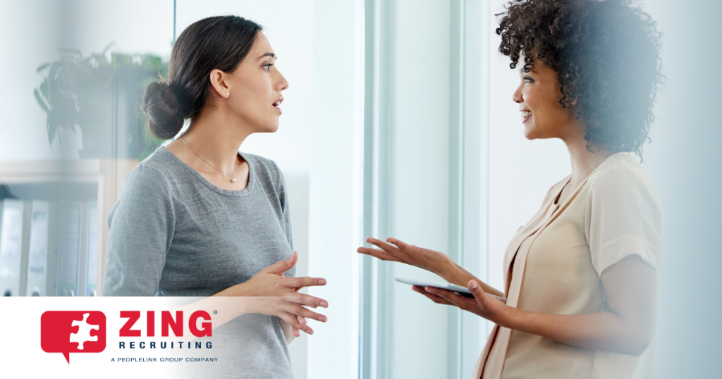 two office professionals in discussion